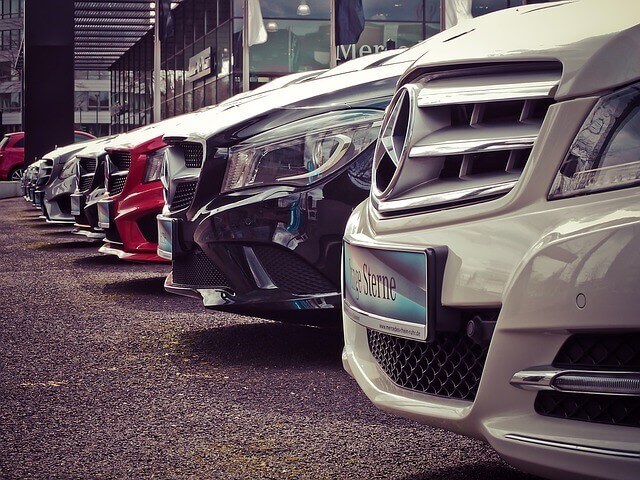 A row of Mercedes-Benz vehicles at a car dealership